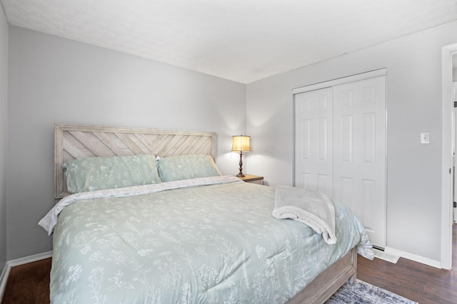 bedroom featuring a closet, baseboards, and wood finished floors