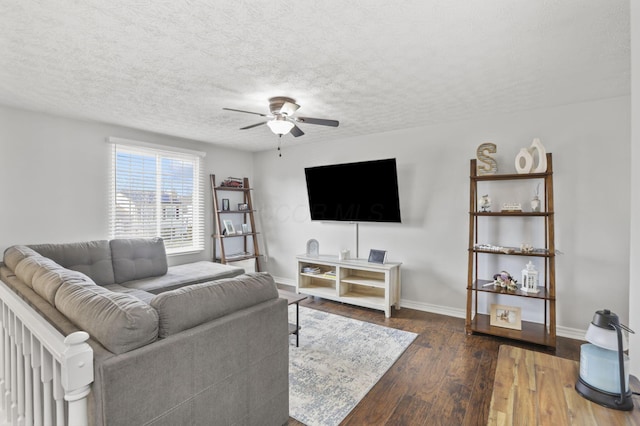 living room featuring baseboards, ceiling fan, a textured ceiling, and hardwood / wood-style floors