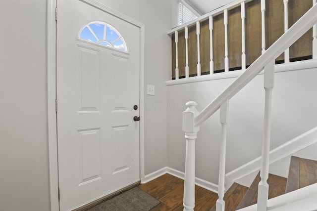 entrance foyer featuring stairs, wood finished floors, and baseboards