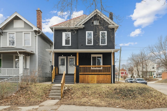 view of front of home featuring covered porch and brick siding