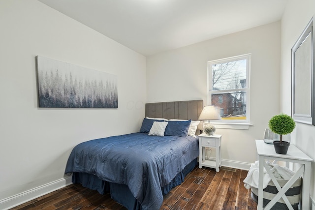 bedroom featuring wood-type flooring and baseboards