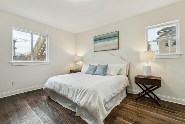 bedroom with baseboards and wood finished floors