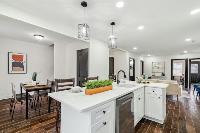 kitchen with wood tiled floor, open floor plan, a sink, and recessed lighting