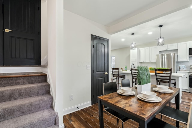 dining area featuring dark wood-style floors, stairs, baseboards, and recessed lighting