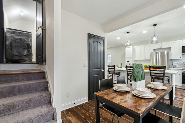 dining room with dark wood-style floors, vaulted ceiling, stairway, and baseboards