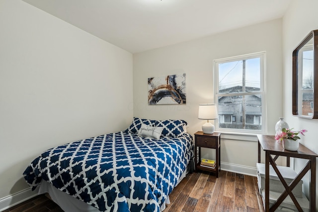 bedroom with wood finished floors and baseboards