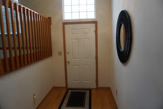 entryway with baseboards and wood finished floors