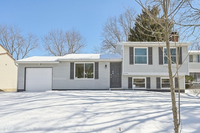 view of front of home with a garage and a chimney