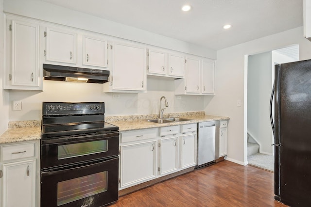 kitchen with white cabinets, a sink, under cabinet range hood, and black appliances