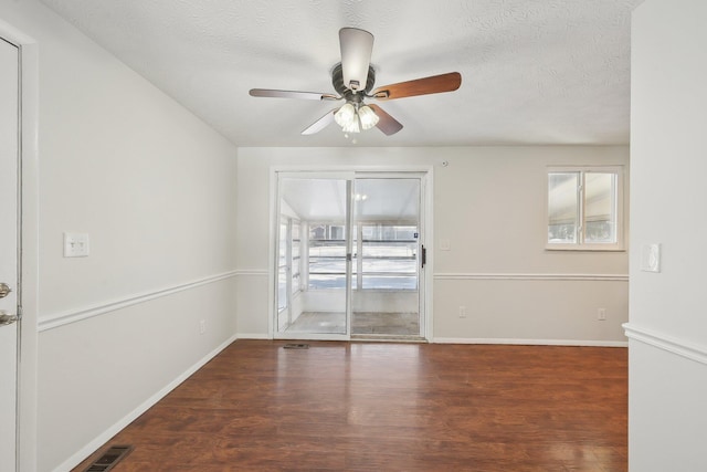 unfurnished room with a ceiling fan, a textured ceiling, visible vents, and wood finished floors