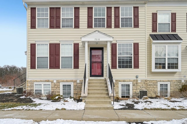 view of front of property featuring stone siding and central AC