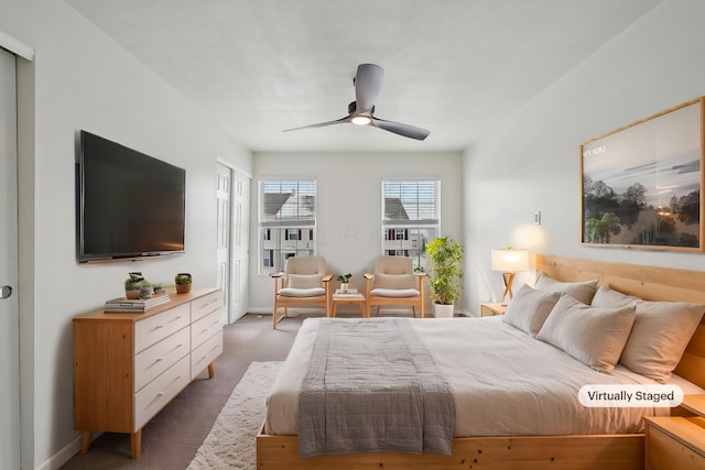 carpeted bedroom featuring a ceiling fan and baseboards