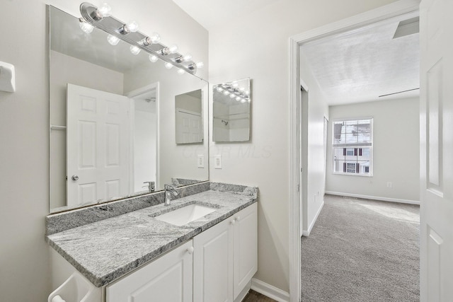 bathroom with vanity and baseboards