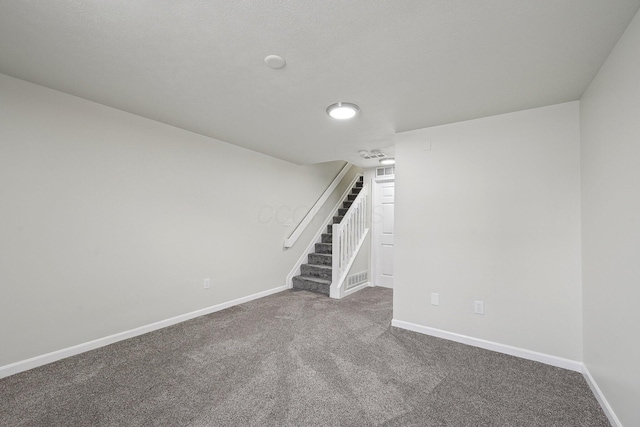 basement with carpet, baseboards, and stairs