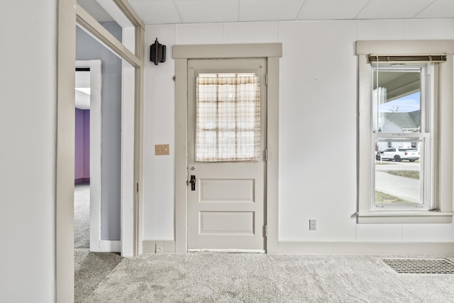 doorway to outside featuring visible vents and carpet flooring