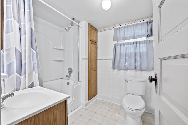 bathroom featuring toilet, tile patterned floors,  shower combination, and vanity