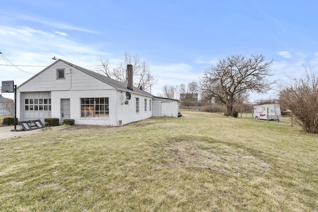 exterior space featuring a chimney and a lawn