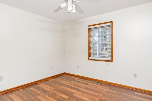 unfurnished room featuring visible vents, baseboards, lofted ceiling, ceiling fan, and wood finished floors