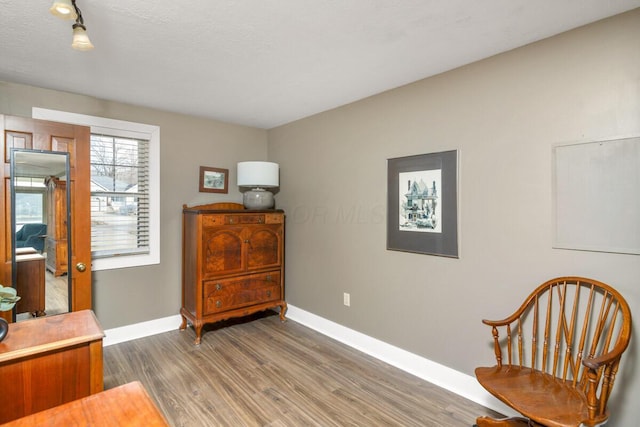 sitting room featuring wood finished floors and baseboards