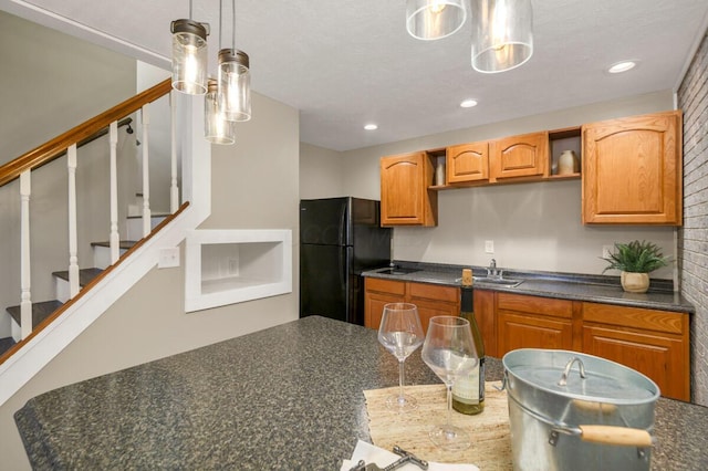 kitchen with freestanding refrigerator, dark countertops, and open shelves