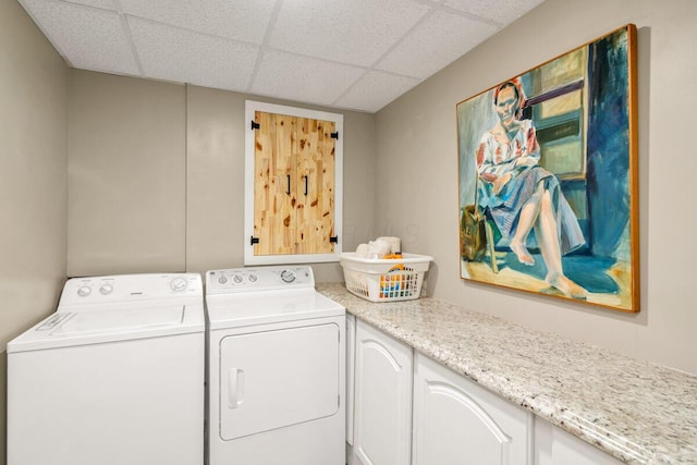 clothes washing area with cabinet space and washer and dryer