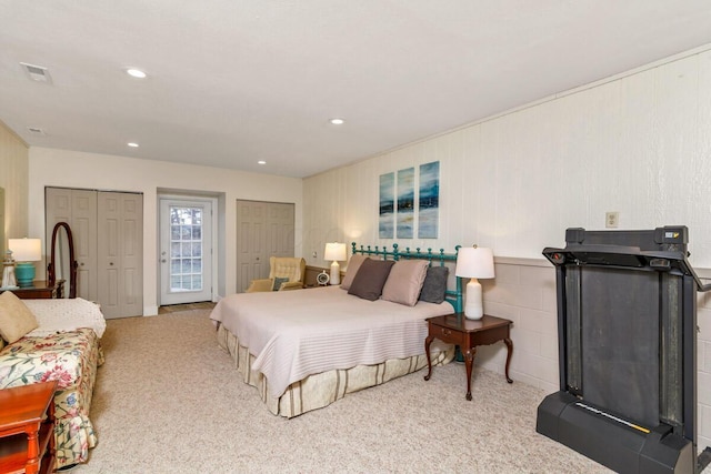 bedroom featuring carpet floors, visible vents, two closets, and recessed lighting