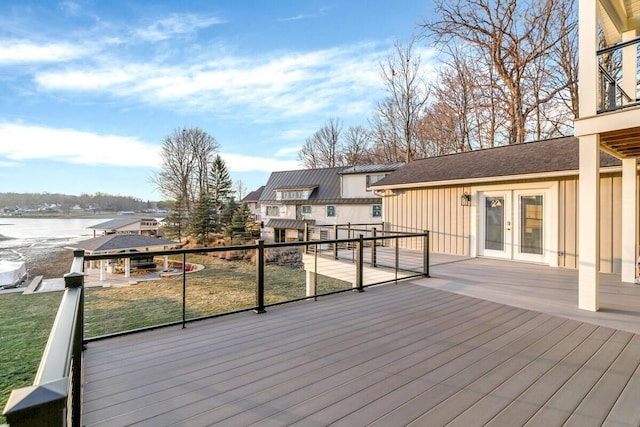 wooden terrace with french doors and a water view