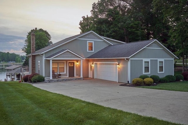 view of front of house featuring concrete driveway, a chimney, an attached garage, a porch, and a front yard