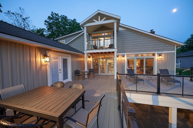 deck featuring outdoor dining space and french doors