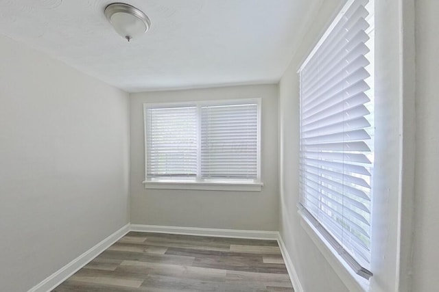 empty room featuring baseboards and wood finished floors