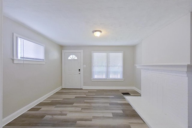 entryway featuring baseboards and wood finished floors