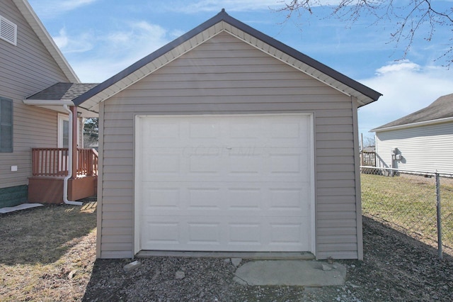 detached garage featuring fence