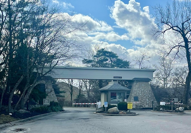 view of street featuring curbs and a gated entry