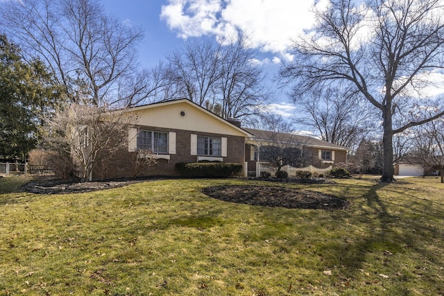 single story home featuring a front yard and brick siding