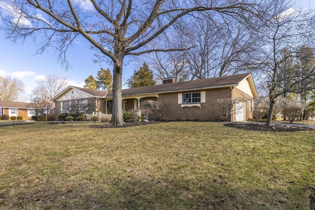 single story home with brick siding, a chimney, and a front yard