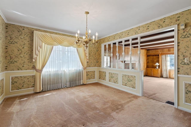 carpeted spare room with wallpapered walls and crown molding