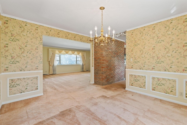 carpeted spare room with wallpapered walls, crown molding, and wainscoting