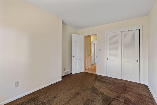 unfurnished bedroom featuring a closet, carpet, visible vents, and baseboards