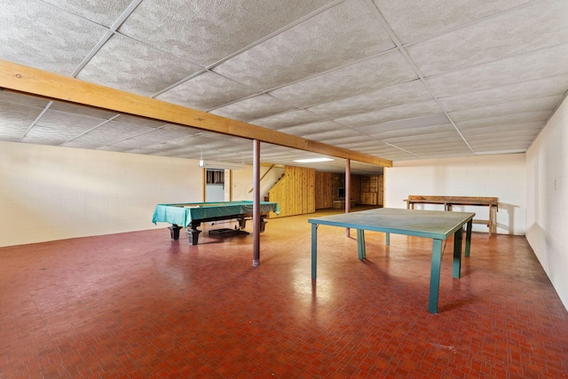 game room with pool table and concrete block wall