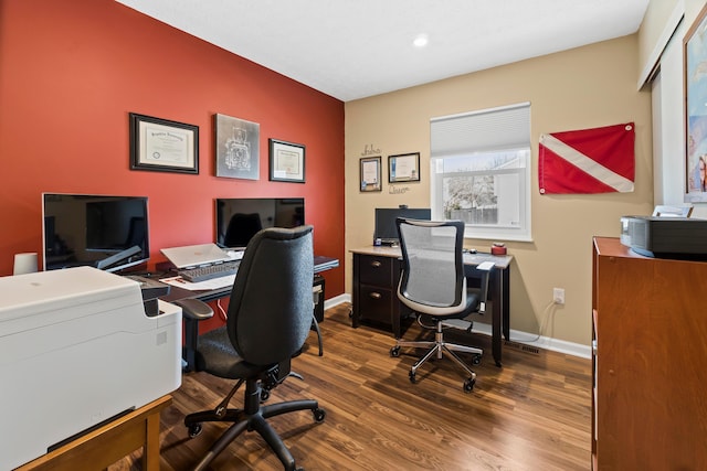 office space with baseboards and wood finished floors