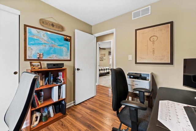 office area with visible vents and wood finished floors