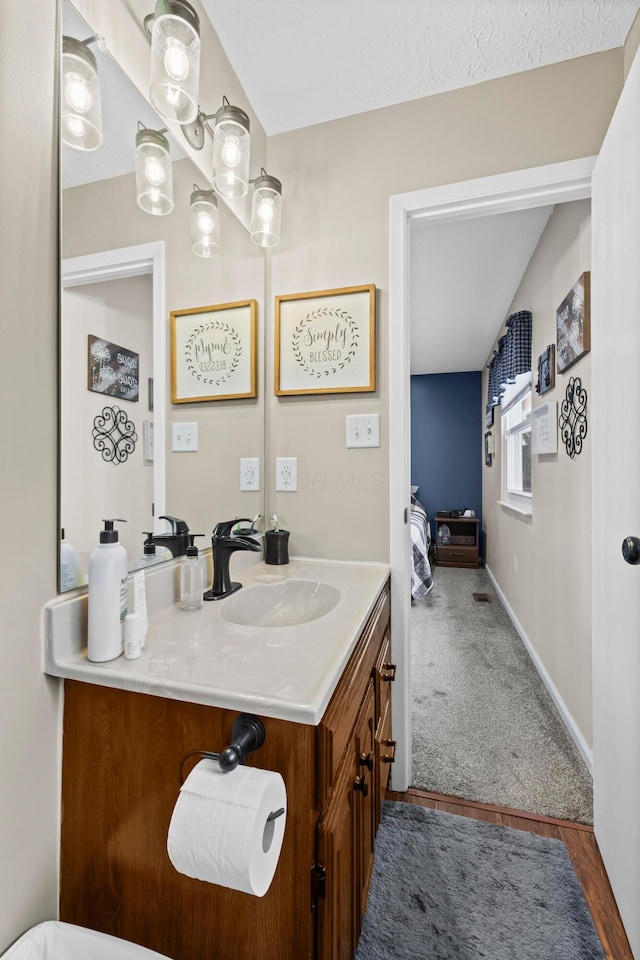 bathroom featuring vanity and baseboards