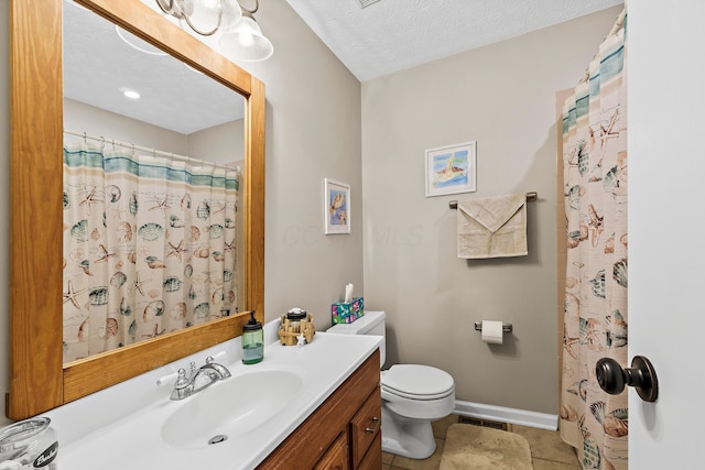 bathroom with a textured ceiling, toilet, vanity, baseboards, and tile patterned floors