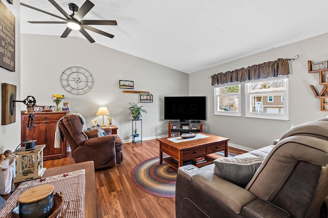 living area with ceiling fan, baseboards, vaulted ceiling, and wood finished floors