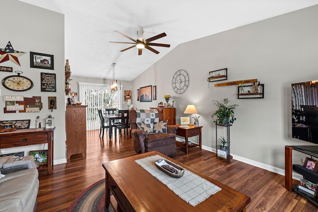 living room with lofted ceiling, ceiling fan with notable chandelier, wood finished floors, and baseboards