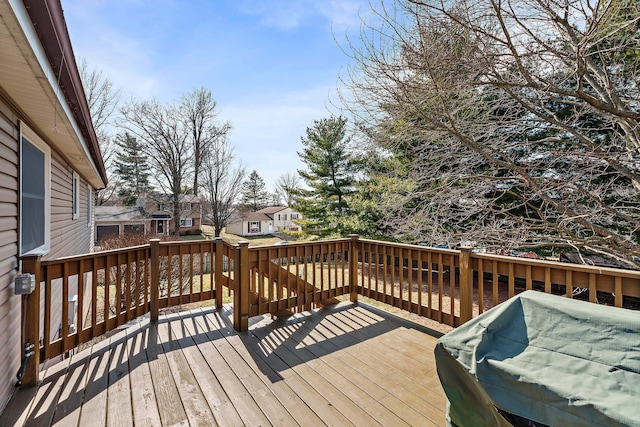 wooden terrace featuring a residential view and area for grilling