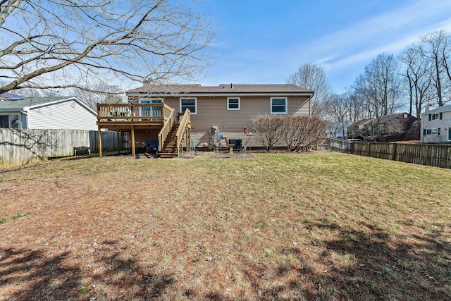 back of house featuring a yard, a fenced backyard, stairs, and a wooden deck