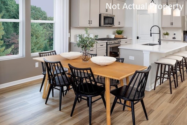 dining space with light wood-style floors and baseboards