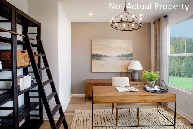 office space featuring a chandelier, wood finished floors, and baseboards