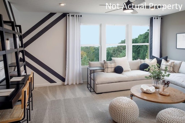 living room with a ceiling fan, carpet flooring, and baseboards